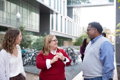 Faculty in conversation outside