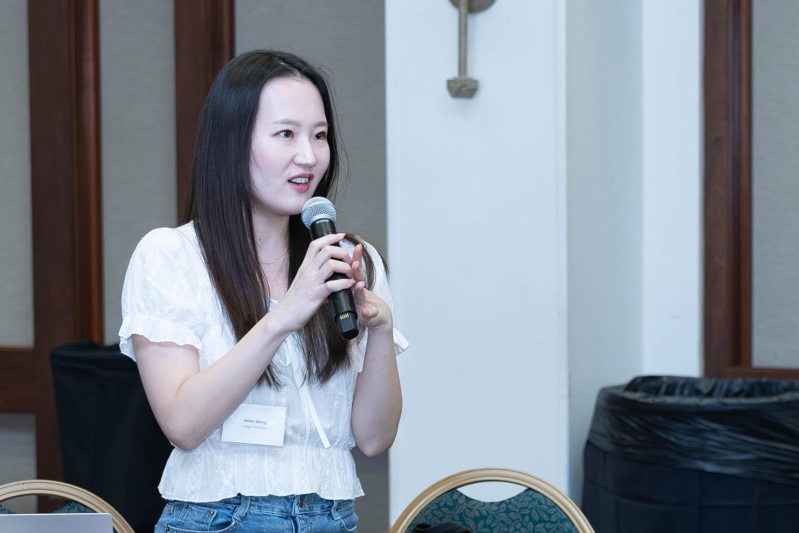 A person holds a microphone.