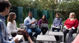 Group of students and faculty meeting outdoors