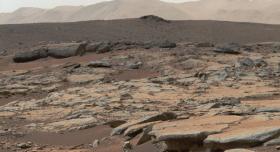 A crater on Mars is made up of brown sedimentary rock.
