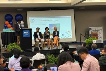 Attendees of symposium sitting on stage