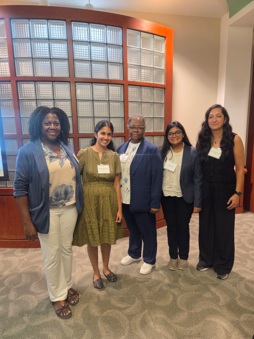 four postdocs and director of postdoctoral affairs stand side by side