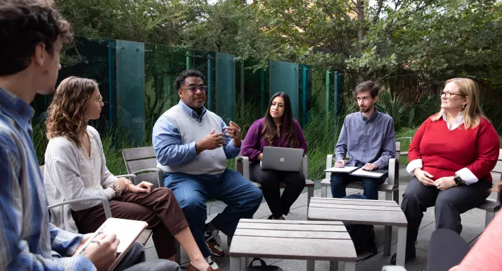 Group of students and faculty meeting outdoors