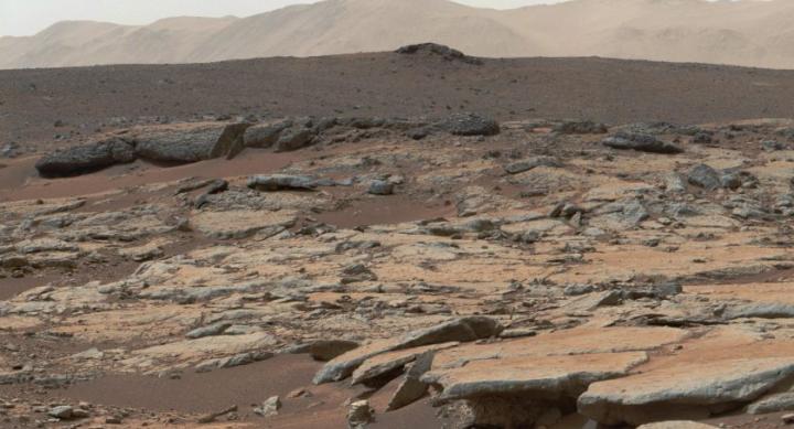 A crater on Mars is made up of brown sedimentary rock.