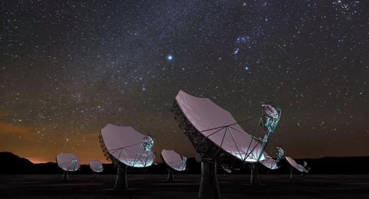Satellite dishes under a night sky.