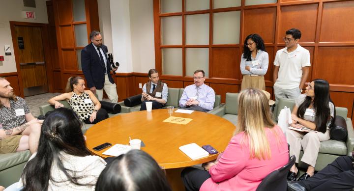 postdocs sitting around a table talking
